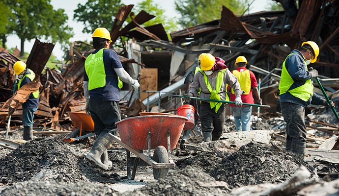 Workers removing debris from collapsed structure Workers removing debris from collapsed structure