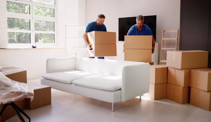 Property restoration team carrying packages in a living room Professionals carrying packages in a living room during property restoration work