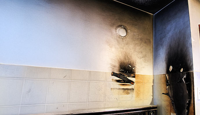 Wall and ceiling damaged by fire and smoke Wall and ceiling with significant fire and smoke damage