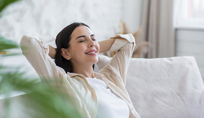 Woman enjoying fresh air in the living room Woman enjoying fresh air in the living room