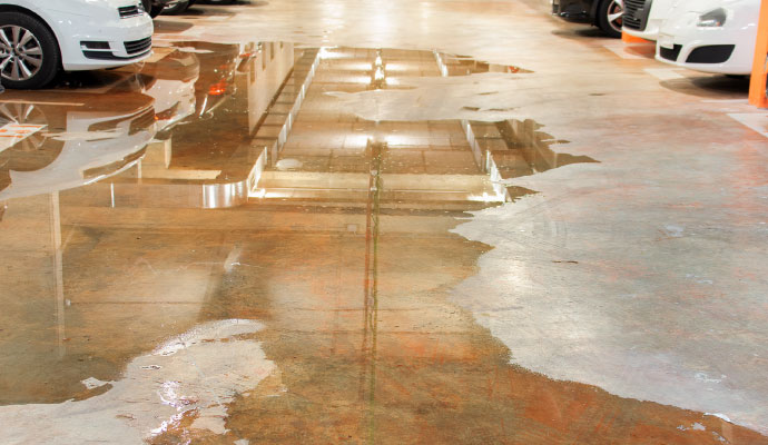 a garage floor damaged by leaking water