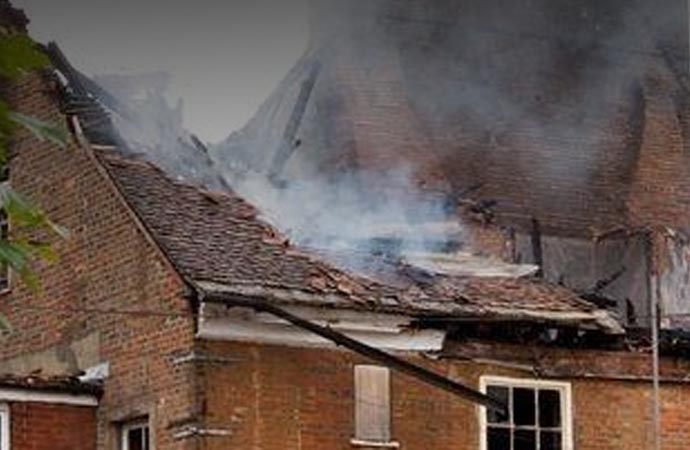 Fire smoke flies on the house roof