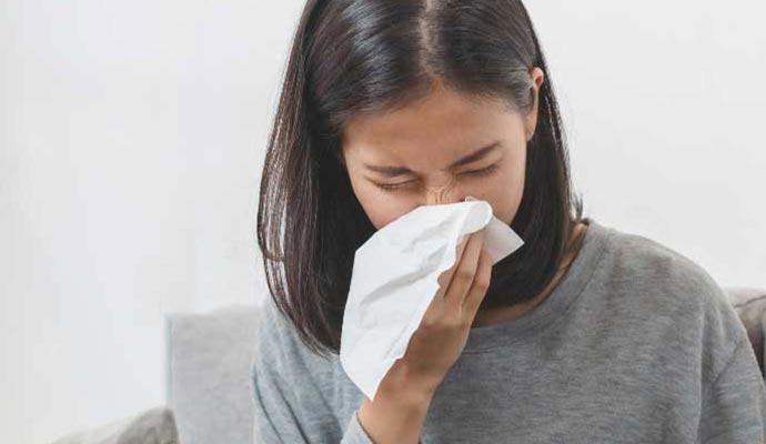 a woman sneezing