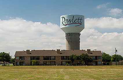 A water tower and residential living area in Rowlett, TX.